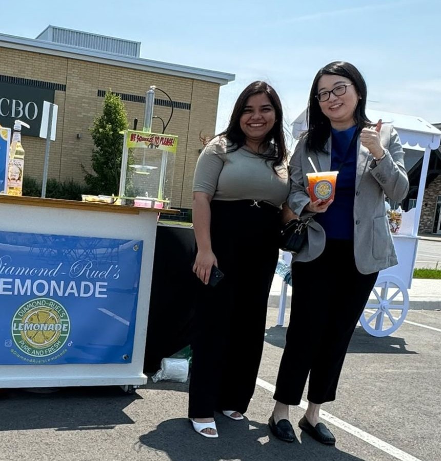 Two guests with lemonade in front of the lemonade cart at the BMO grand opening